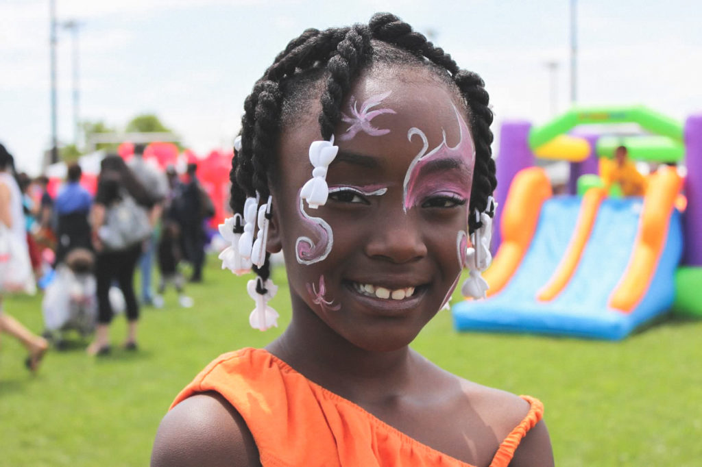 A girl at the Long Island outreach smiles with painted face
