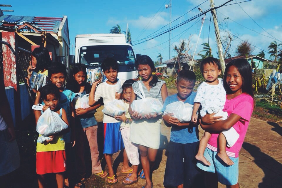 Children receive relief supplies from Convoy of Hope after Typhoon Haiyan left them without food and water.