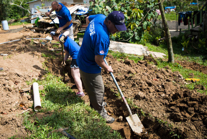 Convoy of Hope volunteers in Puerto Rico dig a hole