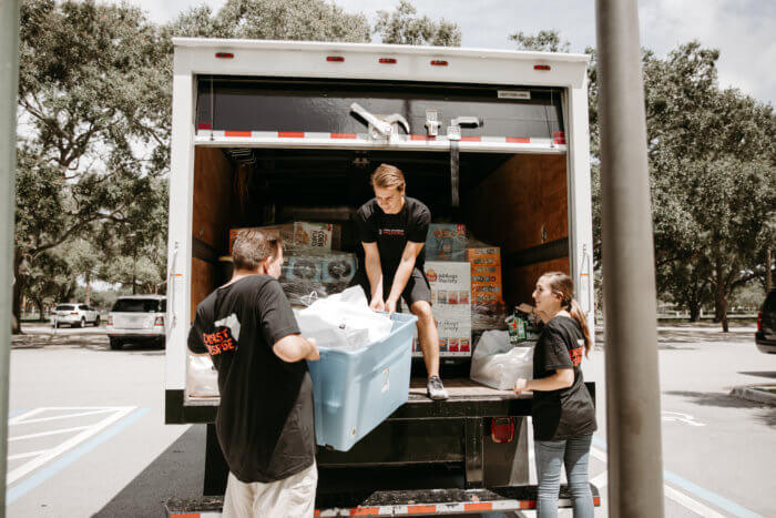 Convoy of Hope volunteers load a truck with supplies