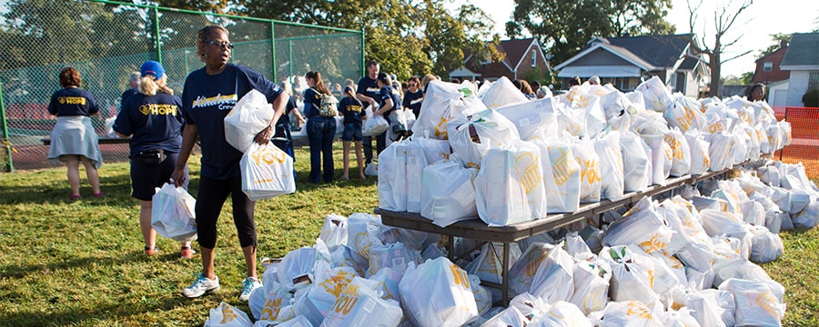 volunteers distribute groceries