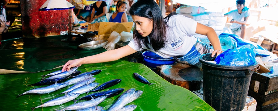 Woman selling fish at a market