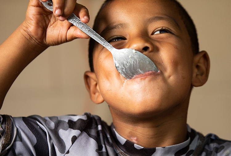Child eating with spoon