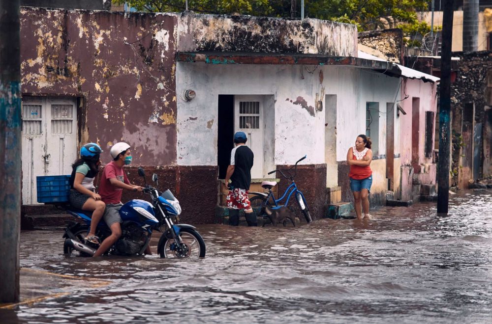 People wade through flooded streets in Mexico