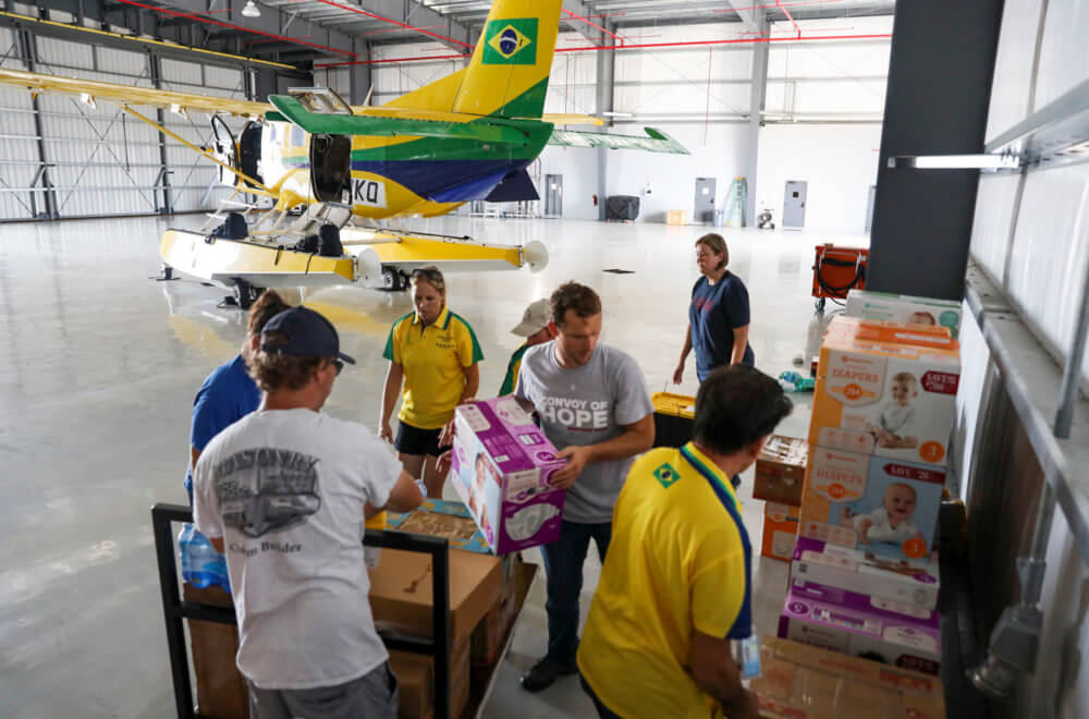 Members of Convoy of Hope's International Disaster Services team, along with volunteers, unpack relief supplies from a chartered plane after arriving in Nassau, Bahamas
