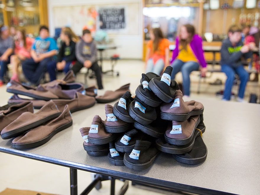 Providing shoes to children is one way to help rural communities.