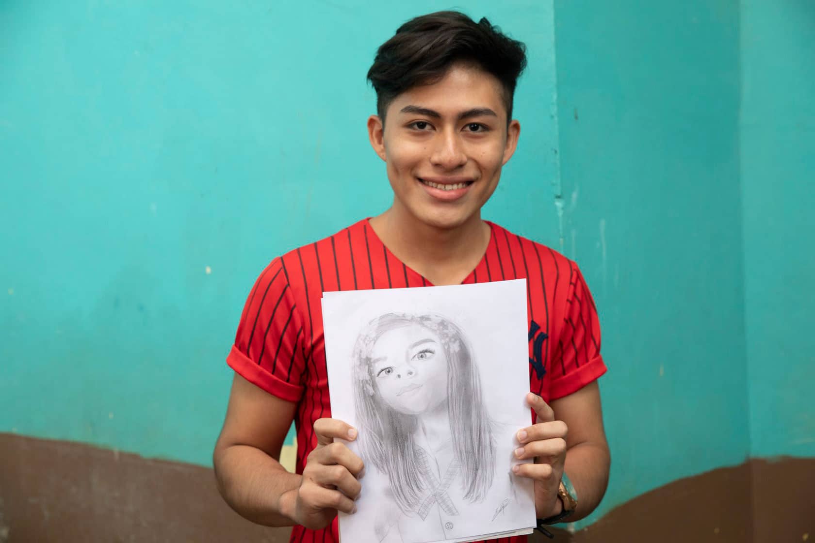 Omar from Honduras holds his drawing