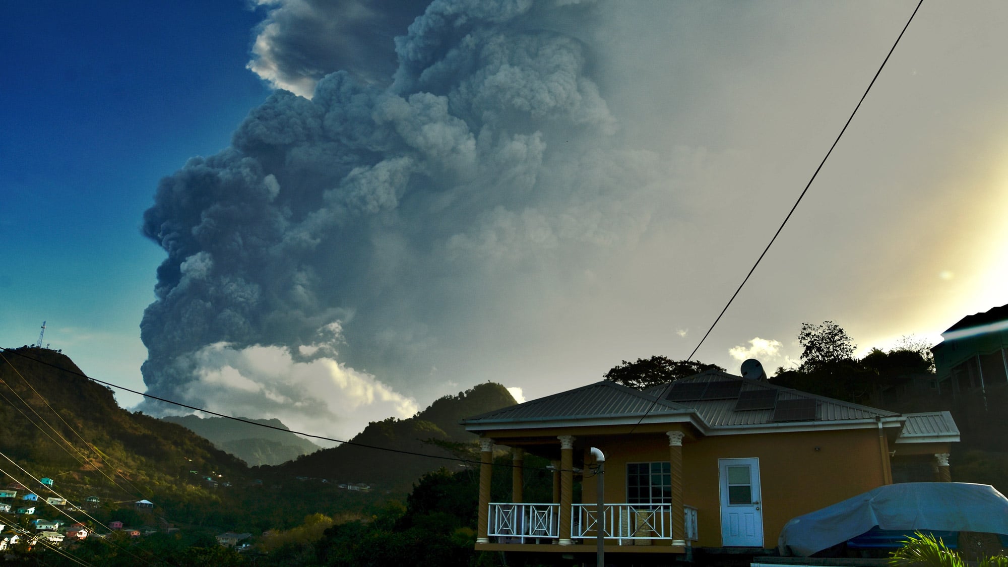 Ash rises into the air as La Soufriere volcano erupts on the eastern Caribbean island of St. Vincent, Tuesday, April 13, 2021. (AP Photo/Orvil Samuel)