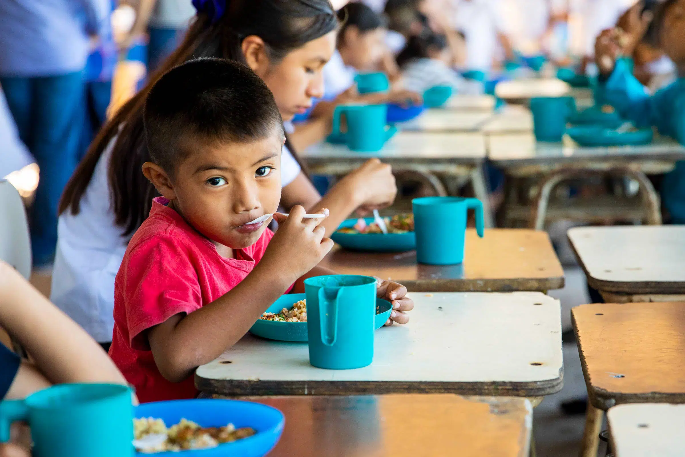 Child eating with spoon.