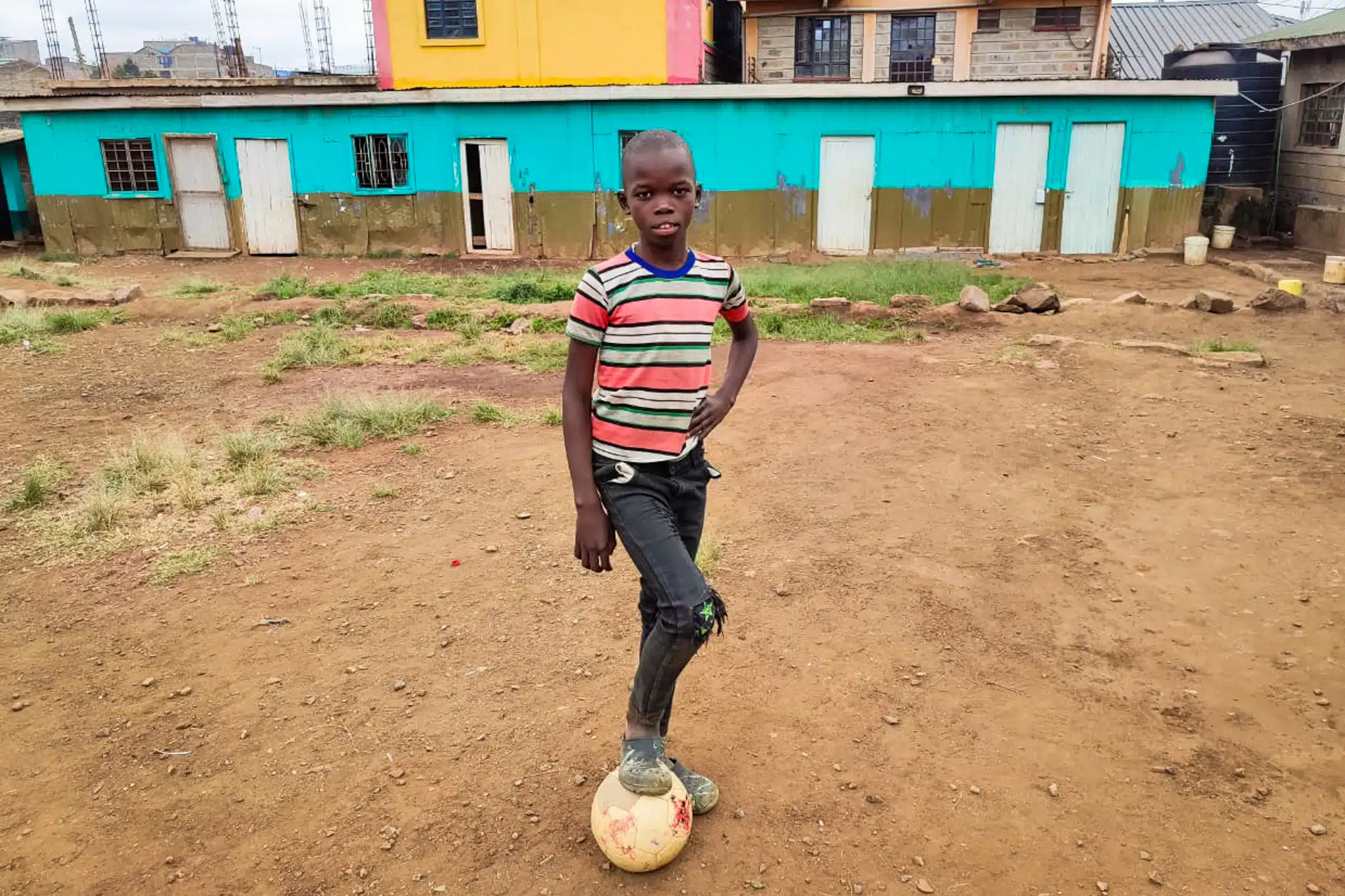 Francis — one of Convoy of Hope's Children's Feeding participants — poses with his soccer ball.
