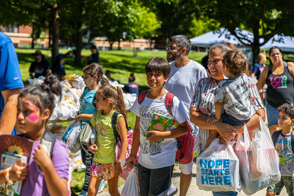 Volunteers distributing food and supplies at a community event
