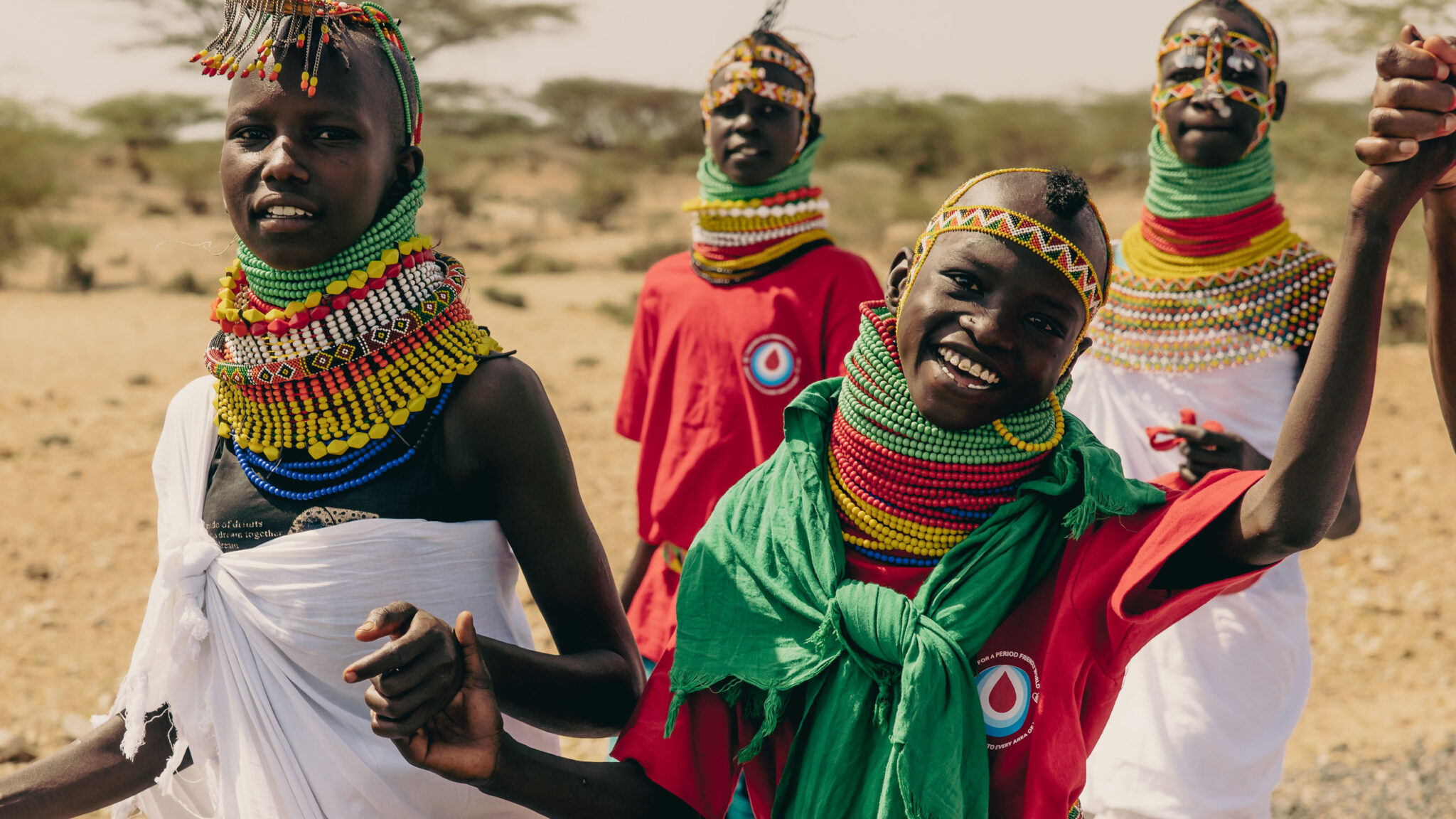 Locals in Turkana Kenya hold hands and smile