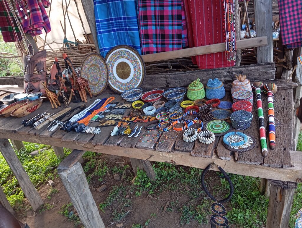 Tome’s Beads and
bracelets collection is displayed on a table, ready for sale.  There is a variety of patterns and colors.