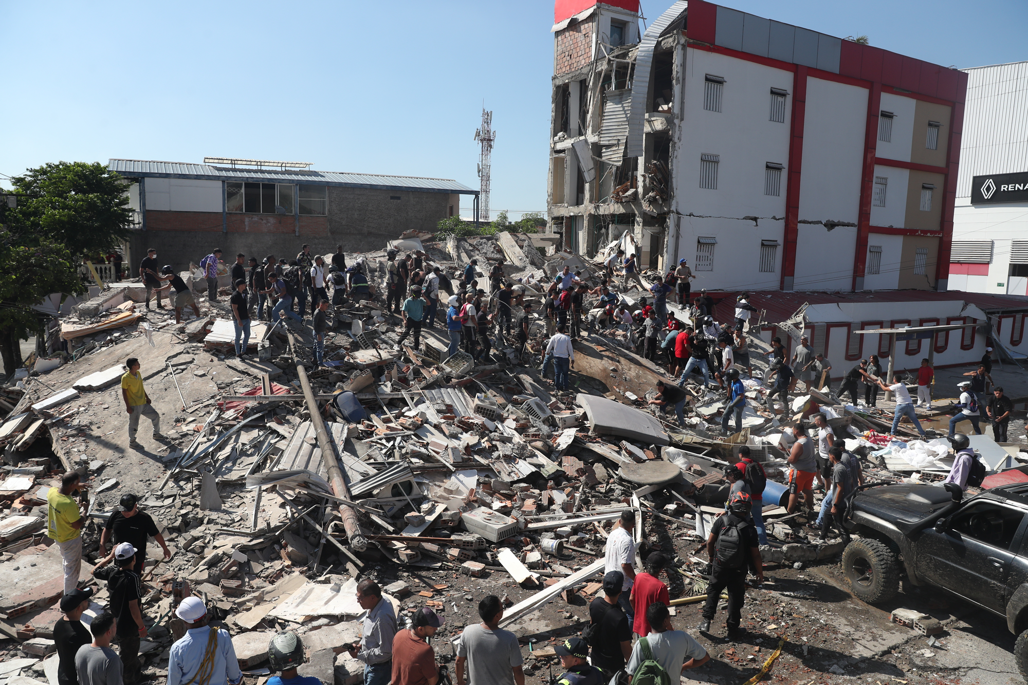 Residents and rescue workers search through the rubble of a collapsed building after an earthquake struck Cali, Colombia, Monday, Aug. 10, 2026. (AP Photo/Santiago Saldarriaga)